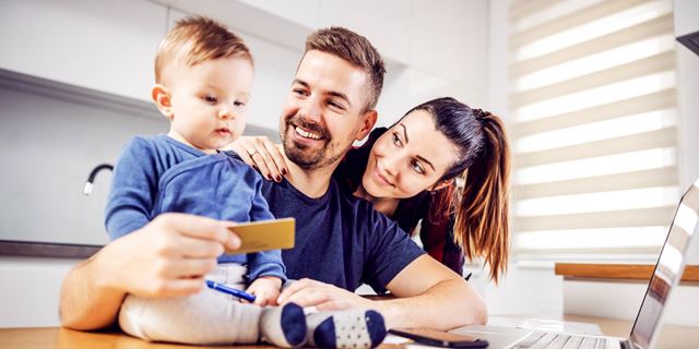 Far og mor ser på sin sønn med et kredittkort